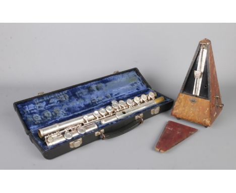 A three piece flute in Gemeinhardt case, together with a Metronome by System Maelzel.