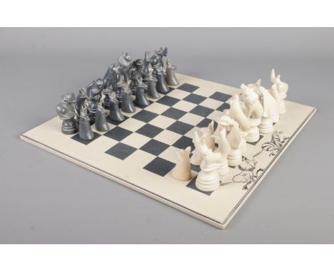 An African themed chess set, featuring carved stone pieces.