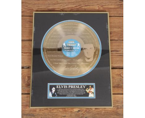 A Framed Elvis Presley Number One Hits limited edition gold disc. 180/2500 with certificates52x41cm