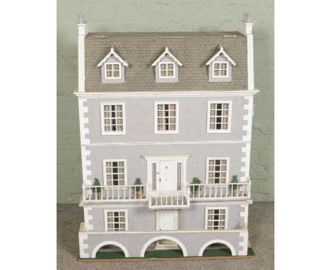 A very large modern three storey dolls house, wired for lighting with accessible attic, size W82 x D43 x H52cm.