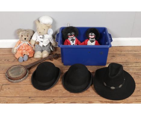 A box of miscellaneous items, including vintage Golly and bear soft toys, four-string steel resonator banjo ukulele, Daines W