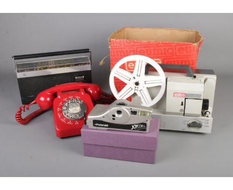A Eumig Mark 501 projector with a rotary telephone, Poloroid Joycam and a Phillips radio