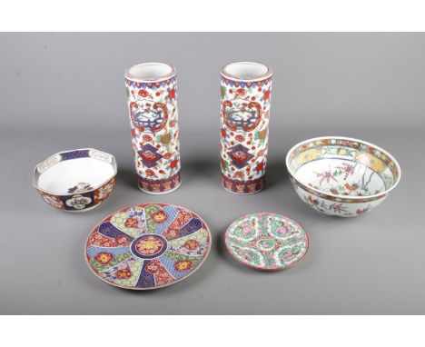 A good collection of oriental ceramics including pair of vases/brush pots, bowls plates etc
