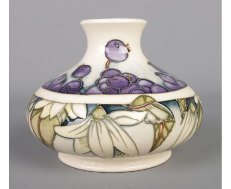 A Moorcroft cream ground squat vase in the 'Juneberry' pattern. Bearing 2000 stamp and impressed leaf to the base, with WM in