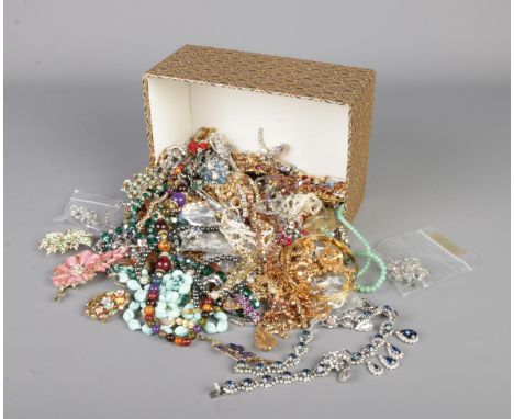 A small box of costume jewellery mostly consisting of necklaces, brooches etc