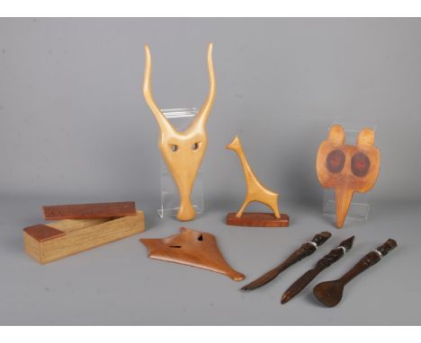 A collection of woodenwares, to include tribal knife, fork and spoon set, giraffe ornament, fox mask and hinged box.