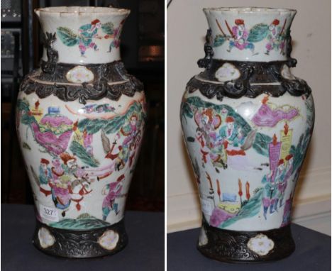 A pair of Chinese pottery famille rose vases with applied decoration and decorated with figures and warriors 