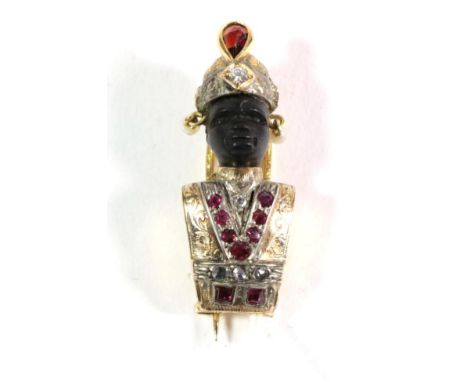 A twentieth century gem set Blackamoor brooch, modelled with a carved ebony face and wearing a turban inset with a rose cut c