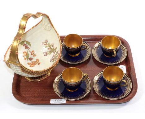 A Royal Worcester blush ivory floral painted basket and a set of four Royal Worcester blue and gilt coffee cans and saucers