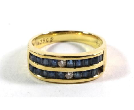 A sapphire and diamond ring, stamped '750', finger size M.  Gross weight - 4.91 grams