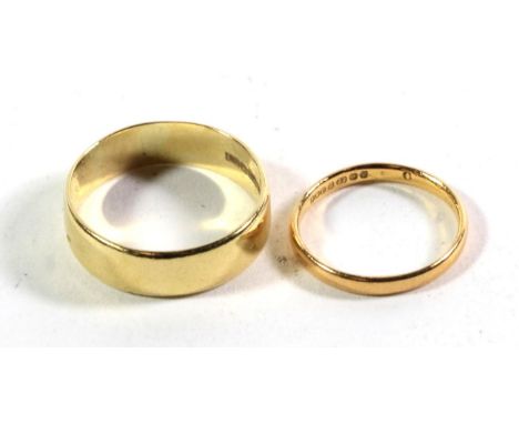 A 22 carat gold band ring, finger size N; and an 18 carat band ring, finger size W (2).  22 carat gold band ring gross weight