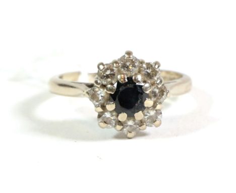 An 18 carat gold sapphire and diamond cluster ring, finger size M.  Gross weight - 4.82 grams. 