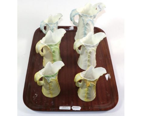Six Royal Worcester yellow, green and blue leaf moulded jugs, tallest 18cm