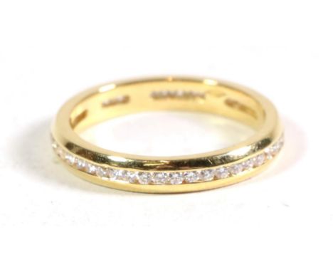An 18 carat gold channel set diamond eternity ring, total estimated diamond weight 0.45 carat approximately, finger size L1/2