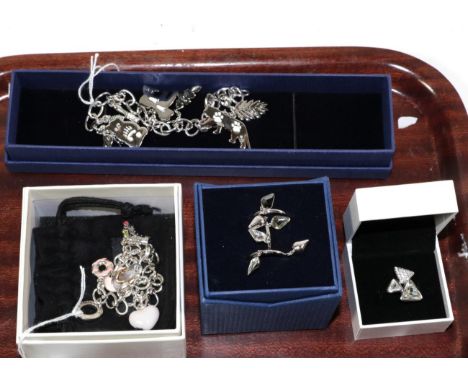A World Wildlife Swarovski animal charm bracelet, boxed; a Swarovski triple ring set; a Swarovski ice ring contained within a
