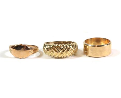 A 9 carat gold band ring, finger size J; a signet ring, finger size N; and another ring, stamped '375' finger size Q1/2 (3). 