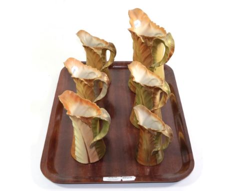 Six Royal Worcester green and gilt leaf moulded jugs, tallest 21cm