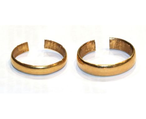 A 22 carat gold band ring (cut); and another band ring, unmarked (cut) .  22 carat gold band ring - 3.13g. Unmarked example -