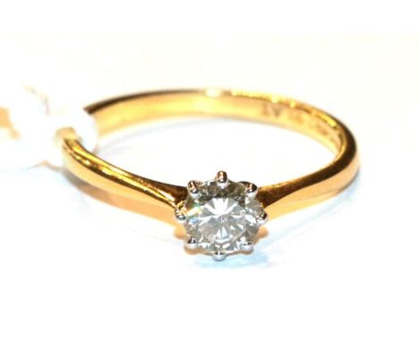 An 18 carat gold solitaire diamond ring, a round brilliant cut diamond in a claw setting, to knife edge shoulders, estimated 