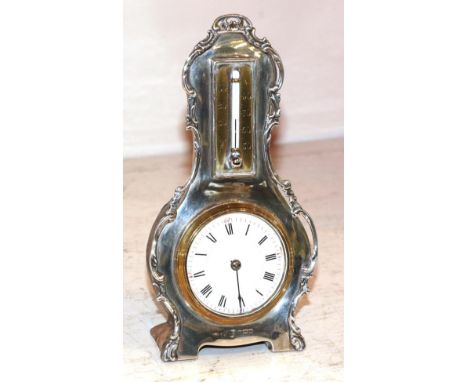 A silver desk timepiece with combined thermometer