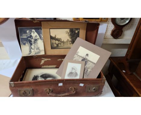A vintage Samson briefcase containing a small collection of monochrome photographs