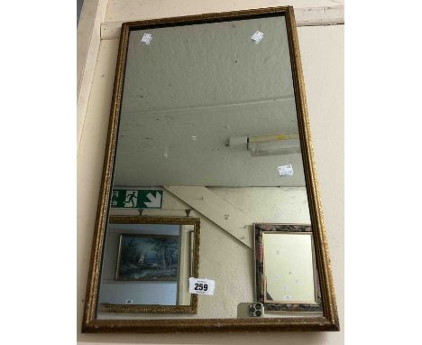 A vintage gilt framed oblong wall mirror with textured border