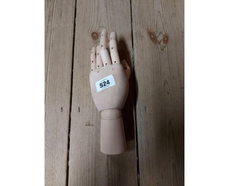 A wooden poseable artist's mannequin hand