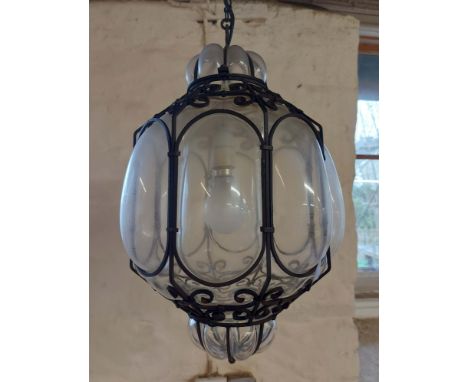 A 1920's bubble glass and wrought iron caged hall lantern