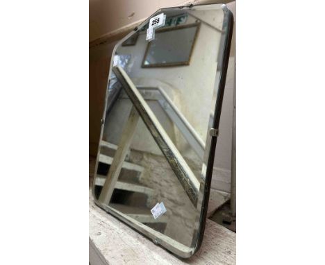 A vintage frameless dressing table mirror with easel back and shaped bevelled plate