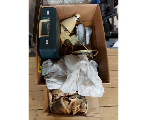 A box containing collectable items including a small desk lamp, a cased Imperial typewriter, vintage dolls house furniture, e