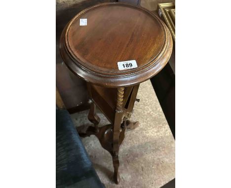 An Eastern hardwood jardinière stand in the antique style with circular top surface and two triangular drawers, set on part b