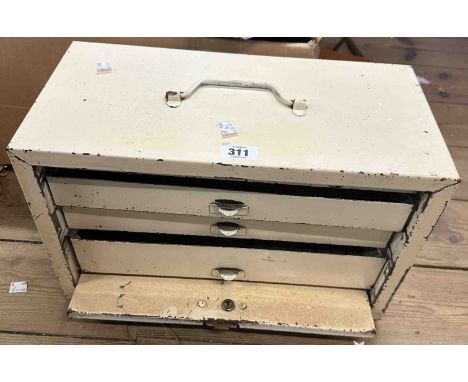 A vintage white painted metal engineer's tool chest of three long graduated drawers enclosed by a slide front