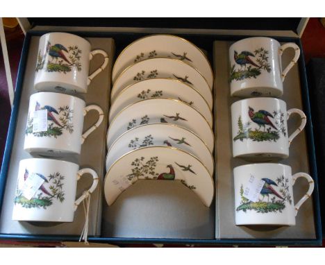 A boxed Royal Worcester bone china coffee set comprising six coffee cans and saucers decorated with exotic birds amidst folia