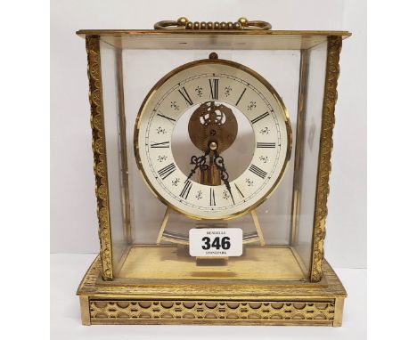 A vintage brass and glazed cased Kundo carriage style electro magnetic timepiece