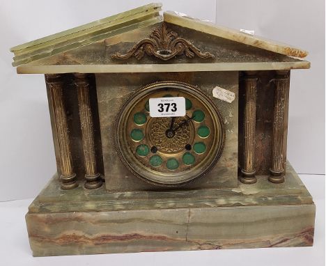A late Victorian brass and green onyx cased mantel clock of architectural design with decorative dial and eight day gong stri