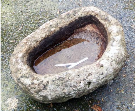A small oval granite trough