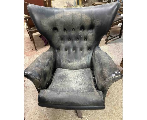 A retro G-Plan 'Blofeld' wingback swivel armchair with button back black upholstery, set on a solid teak base with casters - 