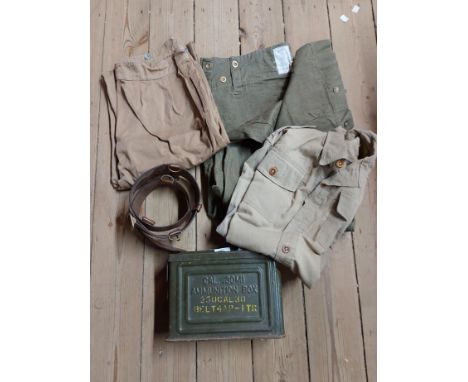 A small green ammunition box, set of army fatigues and a Sam Brown belt