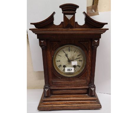 A late 19th Century German oak cased mantel clock of architectural design with silvered dial and Lenzkirch eight day gong str