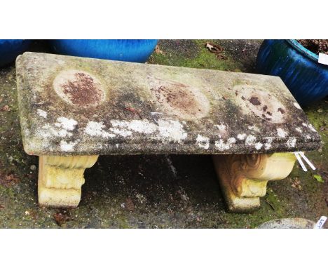 A three piece concrete garden bench of classical form