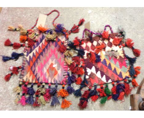 Two vintage North African handmade wool saddle bags, both with polychrome weave and applied tassels
