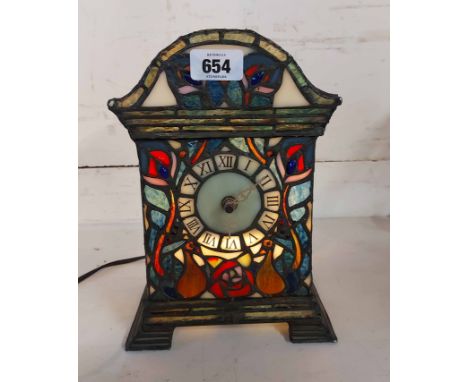 A Tiffany style coloured glass table lamp in the form of a clock (battery movement)