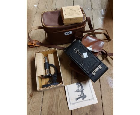 A vintage cased Merit student's microscope - sold with a Kodak folding camera