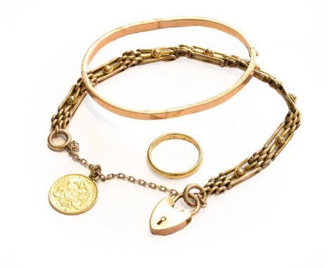 An 18 carat gold band ring, finger size L1/2; a hinged bangle, stamped '15CT' (a.f.); and a gate link bracelet, length 18.5cm