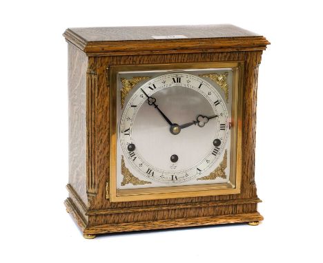 An oak cased striking Elliot mantel clock, and paperwork and key