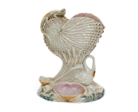 A 19th century Royal Worcester centre piece, formed as nautilus shell, surmounted by a lizzard, the pedestal formed as a mute