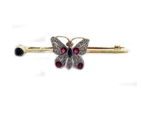 An 18 carat gold synthetic sapphire, synthetic ruby and diamond butterfly brooch, the butterfly set throughout with a marquis