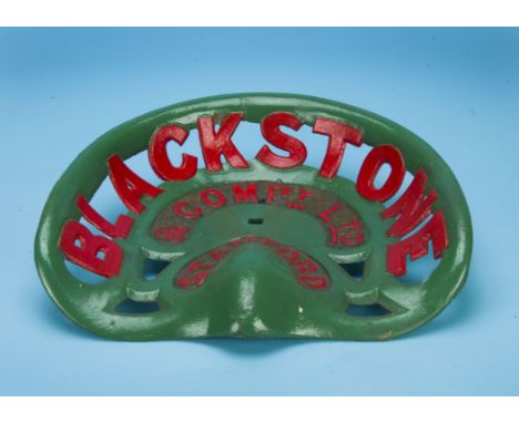 A vintage cast iron tractor seat by Blackstone & Co,  painted in green and red 