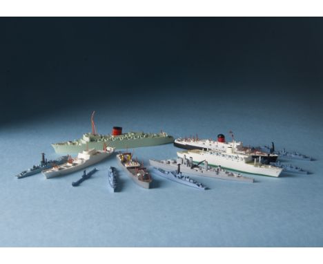 A collection of diecast waterline models of ships and boats, in two K-Bins, including naval, merchant and civilian examples b