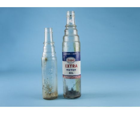 A one quart glass oil bottle, with blue, white and red "Esso Extra Motor Oil" painted label together with a glass, one pint e